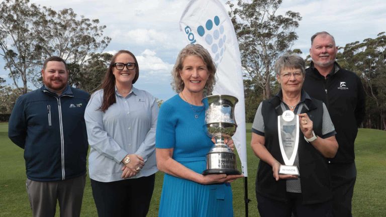 five officials standing with a golf trophy