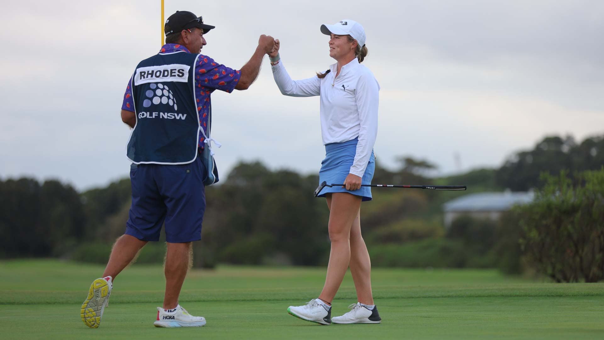 female golfer fist bumps after a round