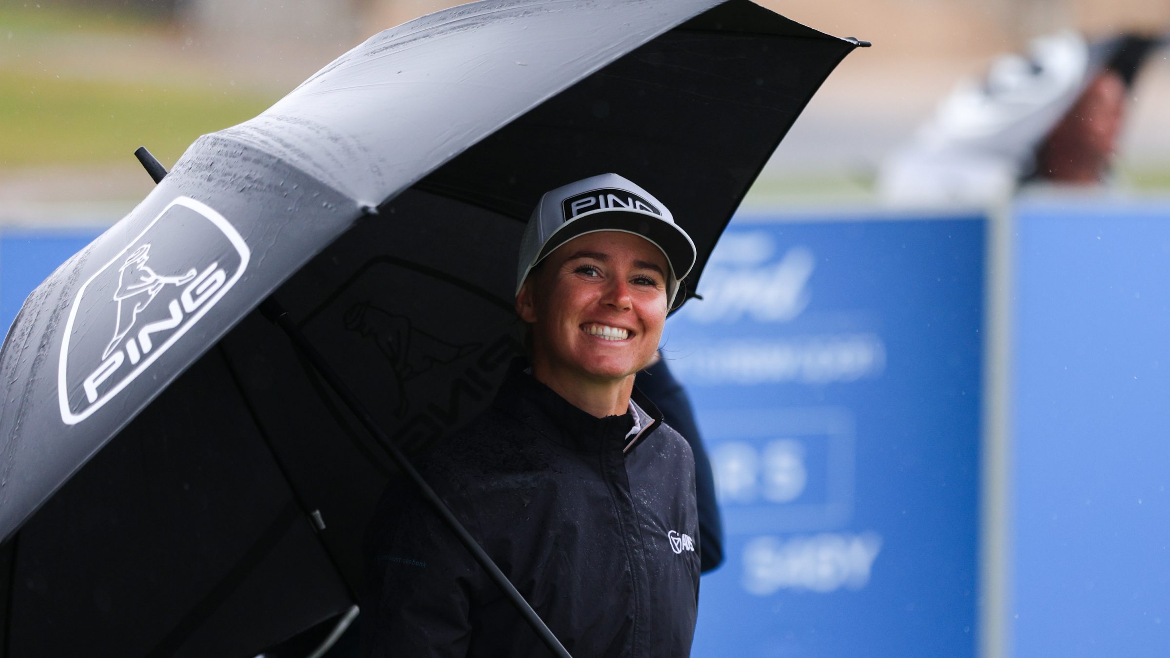 Kelsey Bennett smiling under an umbrella